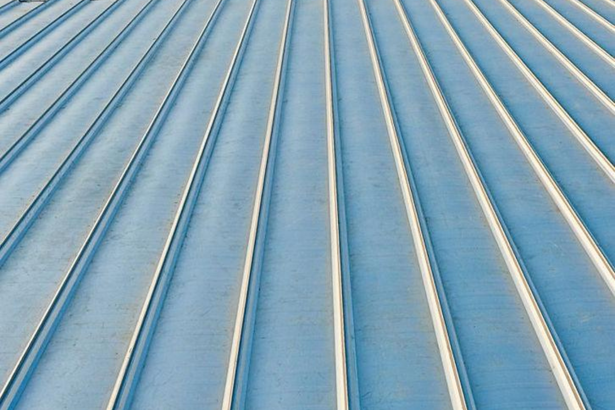 Metal roofing panels with raised standing seams