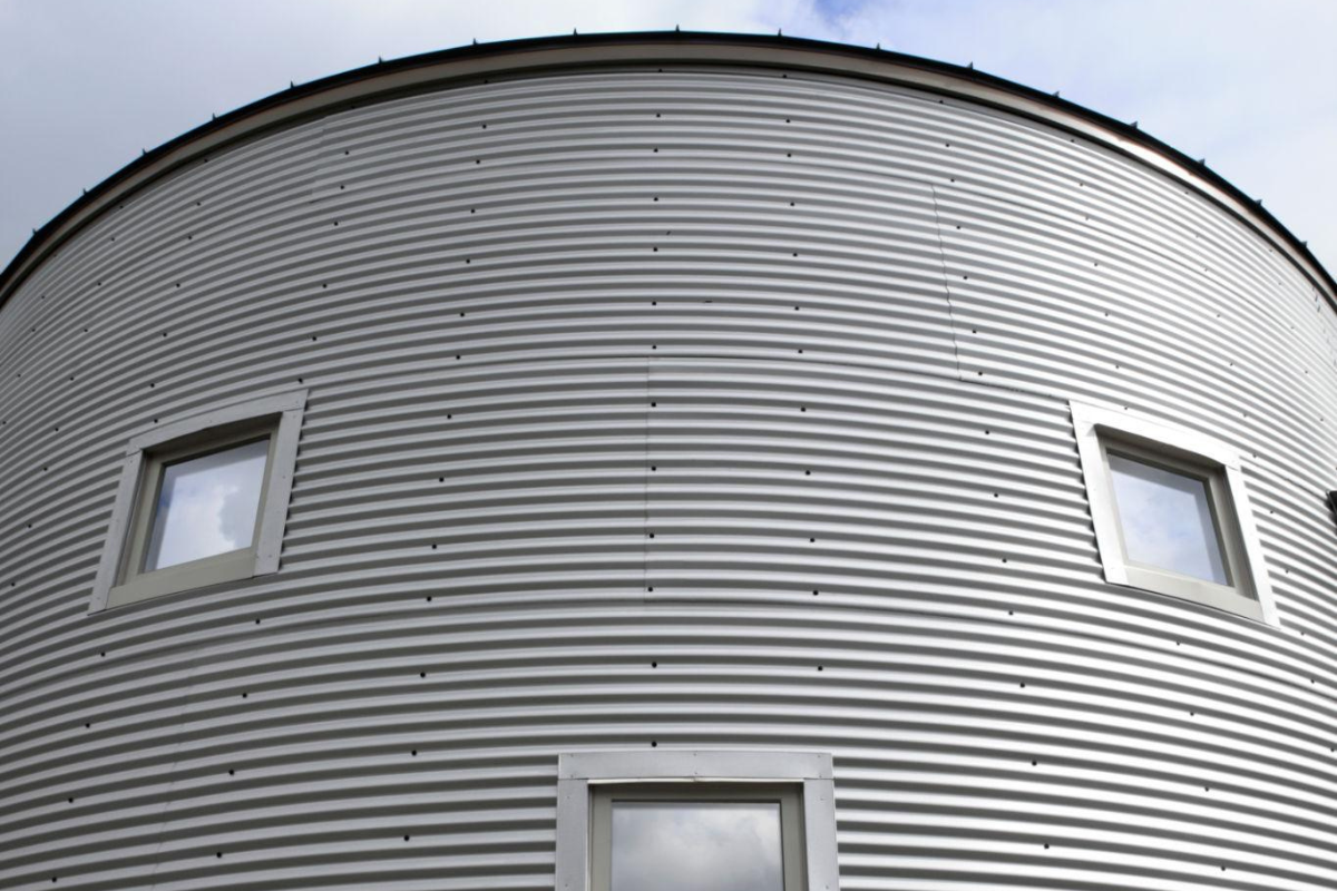 Curved metal roofing structure illustrating industrial roofing