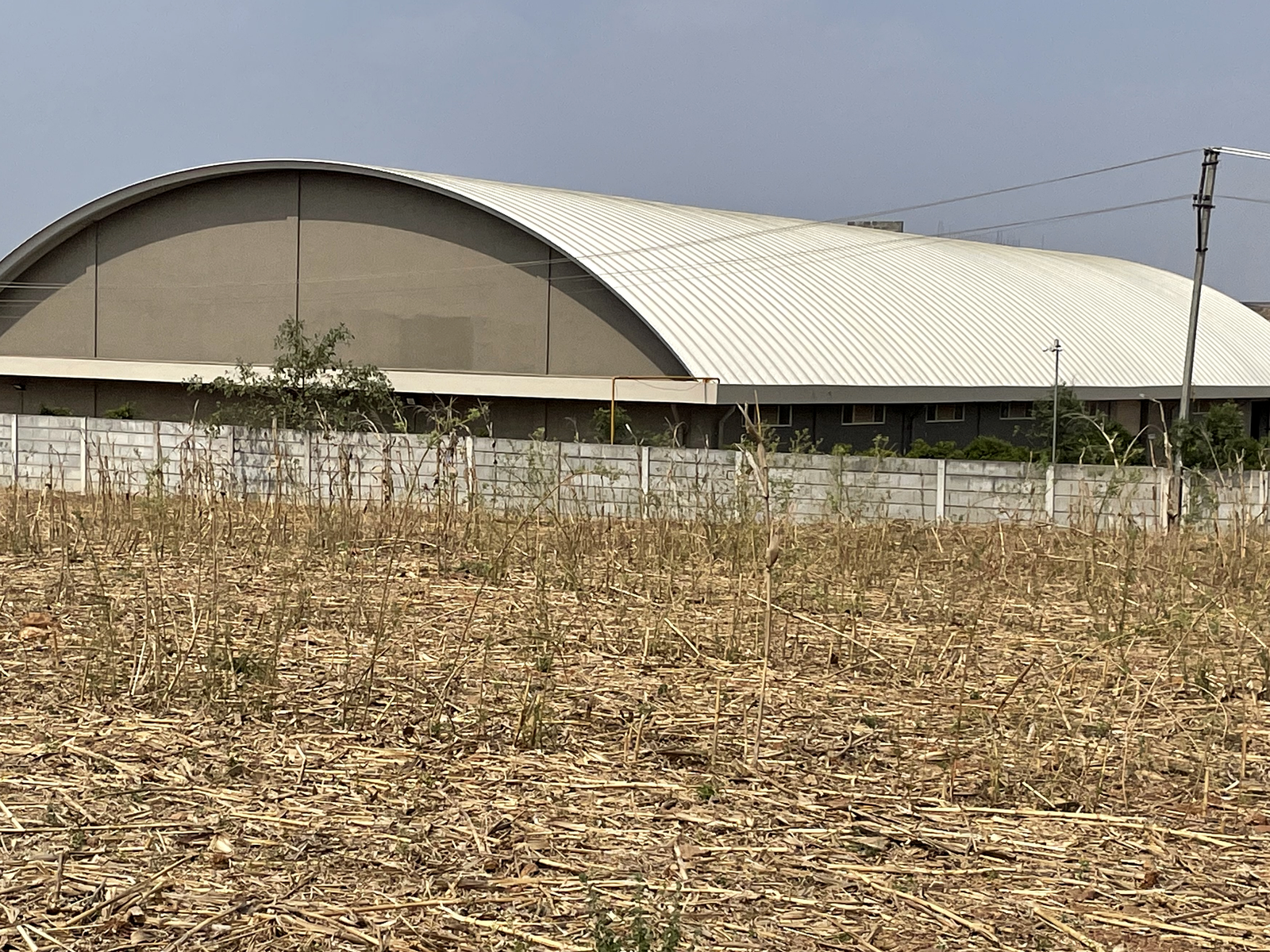Industrial building project with a large metal roofing system.