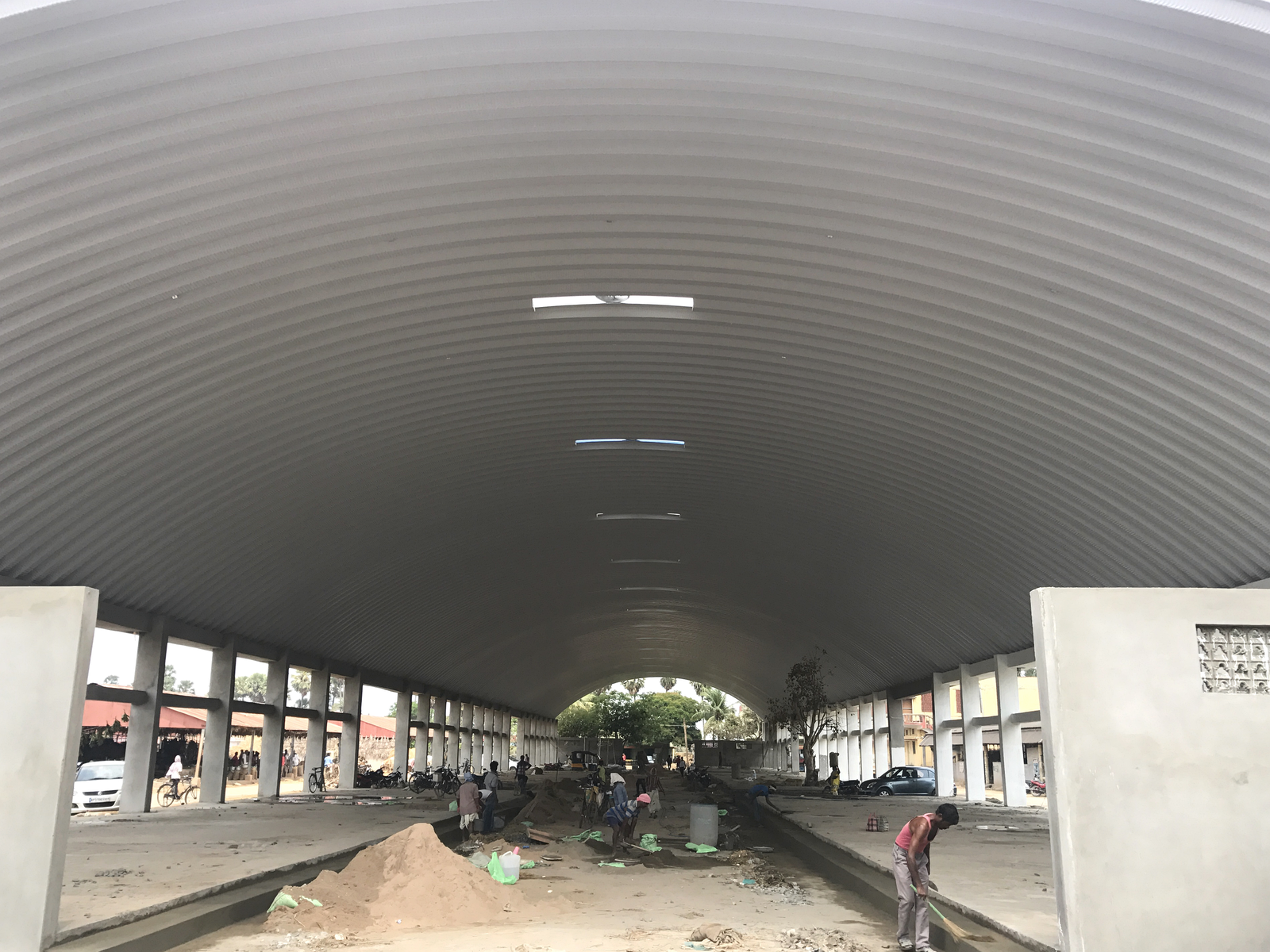 Interior view of the industrial building showing the underside of the roof and supporting structure.