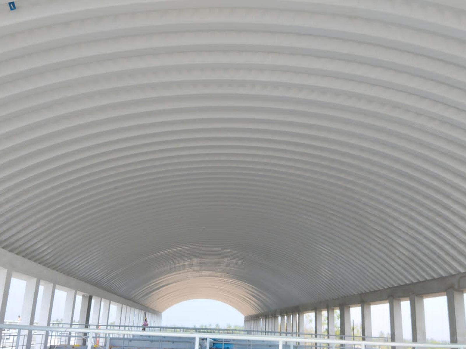 Interior view of a conventional hall showing the clear internal span beneath the curved roof.