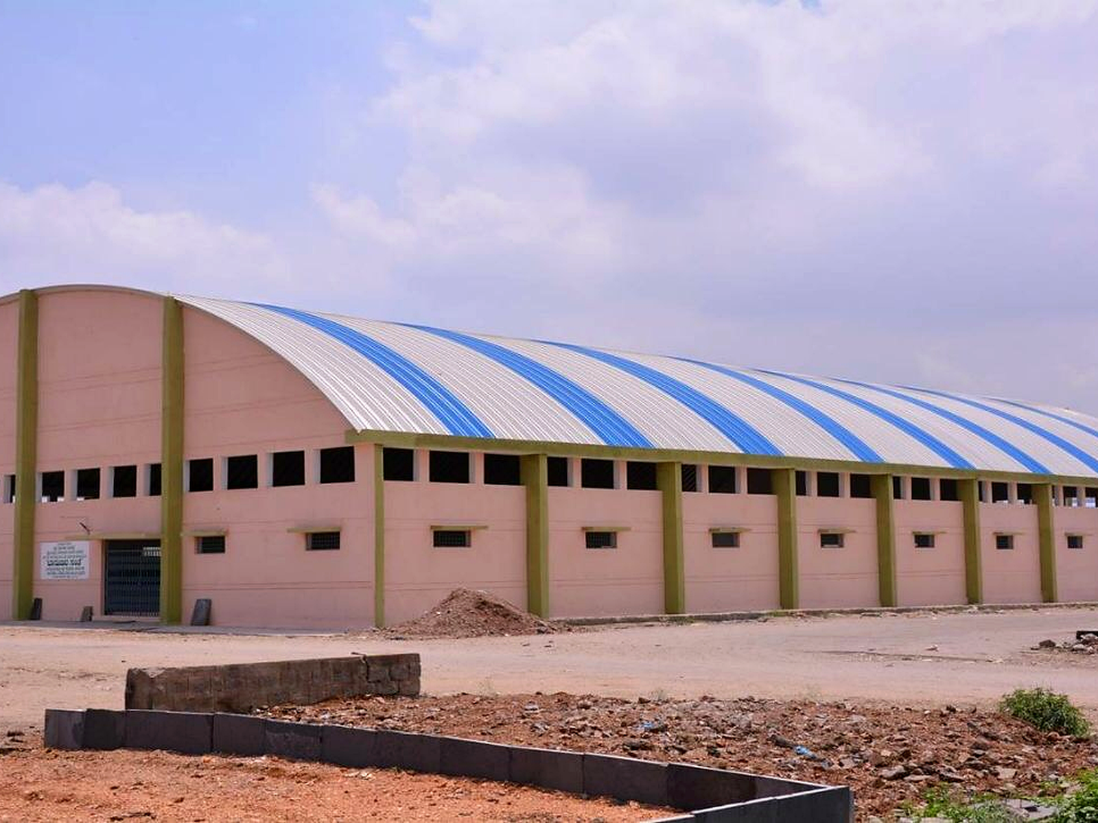 Factory building showing a long industrial roof form and manufacturing-facility exterior.