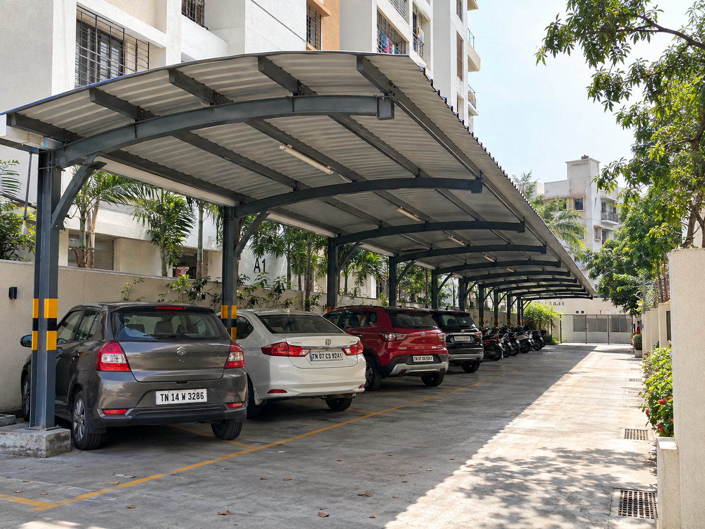 Covered parking shed showing vehicle access, sheltered parking bays and the roof structure.