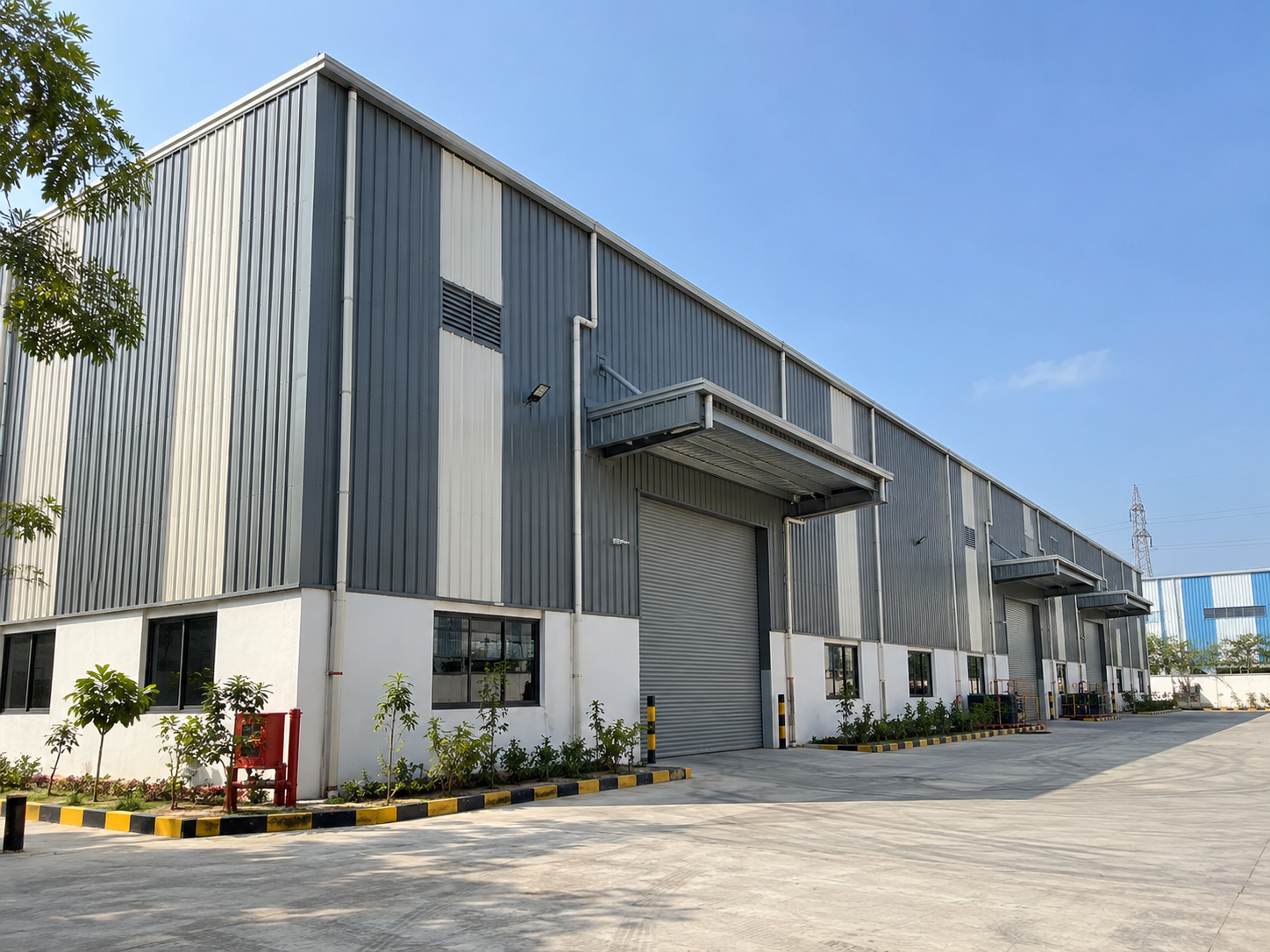 Industrial building elevation showing vertical wall cladding, openings, trims and panel alignment.