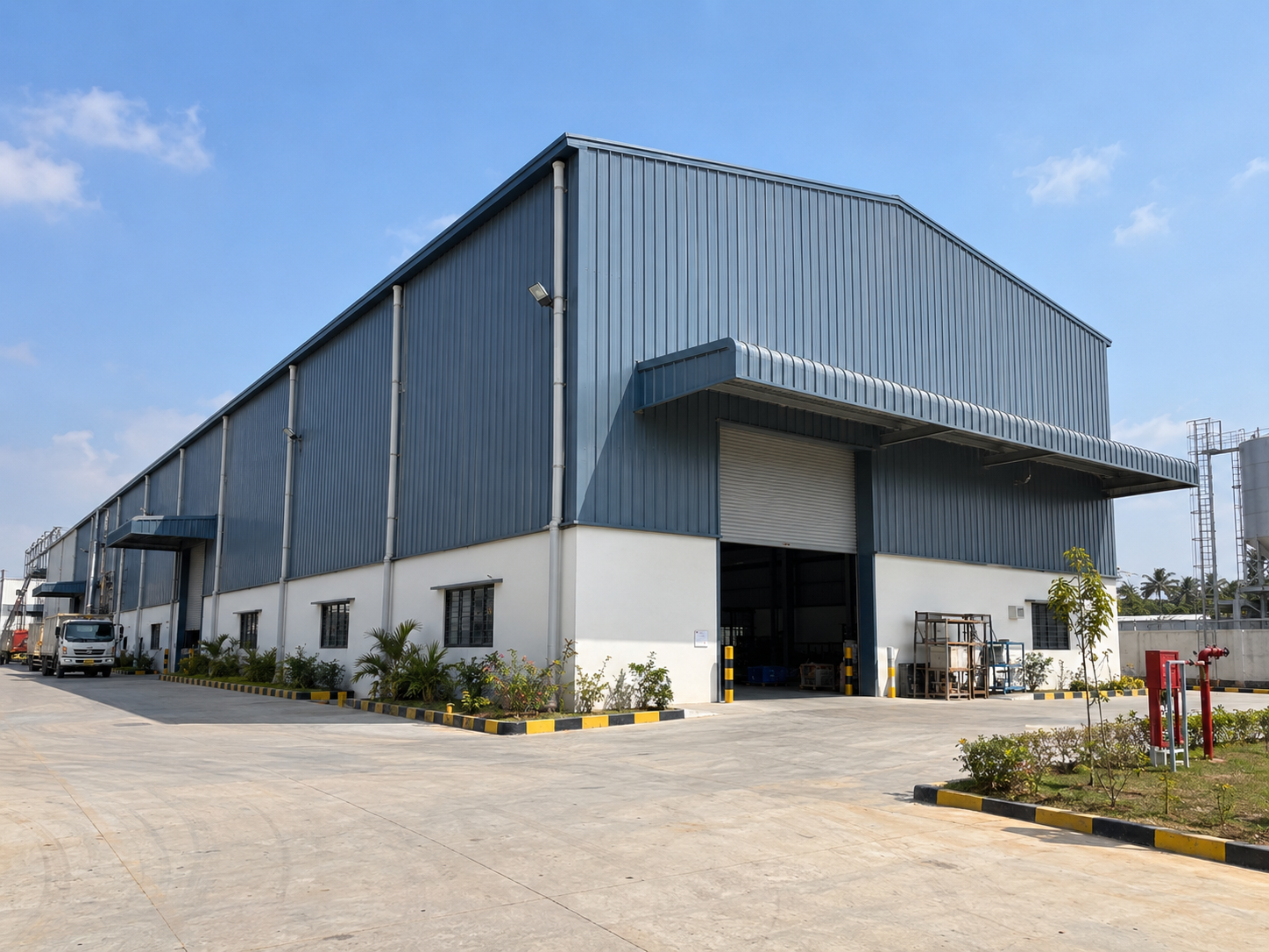 Industrial building showing coordinated metal roof and wall cladding across the completed building envelope.